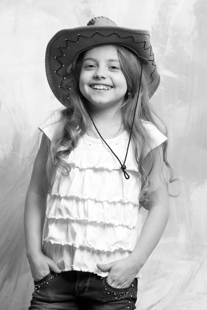 child, little smiling girl in cowboy hat on colorful background - Φωτογραφία, εικόνα