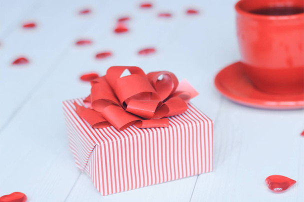 close-up background image of red Cup and gift box on light background. - Photo, image