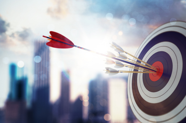Arrow hit the center of target with modern skyscraper background. Business target achievement concept. 3D Rendering - Photo, Image