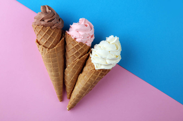 Vanilla frozen yogurt or soft ice cream in waffle cone. - Φωτογραφία, εικόνα