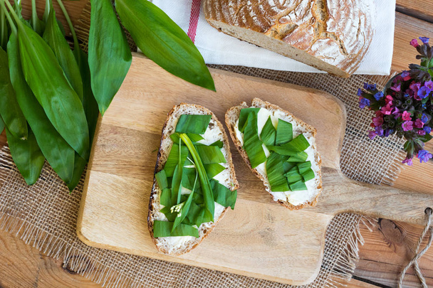 Two slices of sourdough bread with butter and wild garlic - Photo, Image