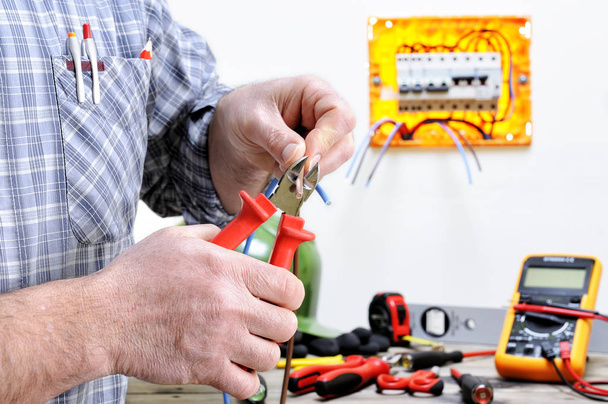 Electrician technician at work on a residential electric system - Photo, Image