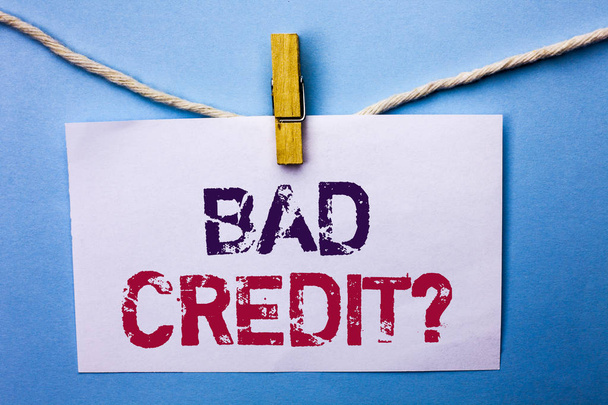 Text sign showing Bad Credit Question. Conceptual photo Low Credit Finance Economic Budget Asking Questionaire written on White Note Paper hanging with rope on the plain background Clip. - Photo, Image