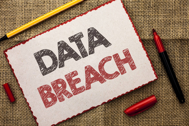 Writing note showing  Data Breach. Business photo showcasing Stolen Cybercrime Information Hacking Security Malicious Crack written on Cardboard Piece on the jute background Markers next to it. - Photo, Image