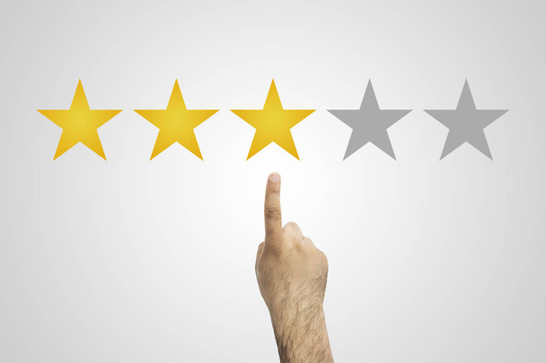 Rating golden stars. Feedback, reputation and quality concept. Hand pointing, finger pointing to five star rating. Customer review concept - Photo, Image