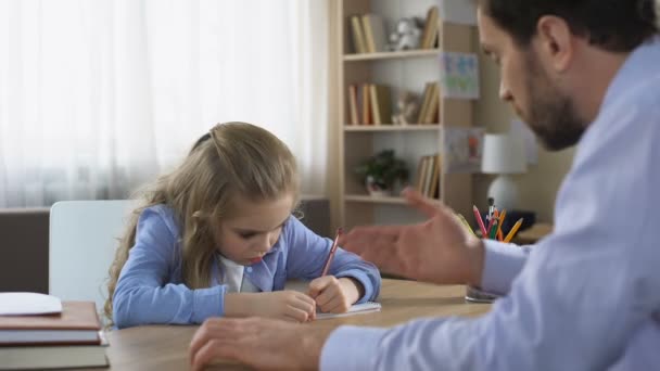 Strict dad talking to daughter doing homework, parental control, education - Filmagem, Vídeo