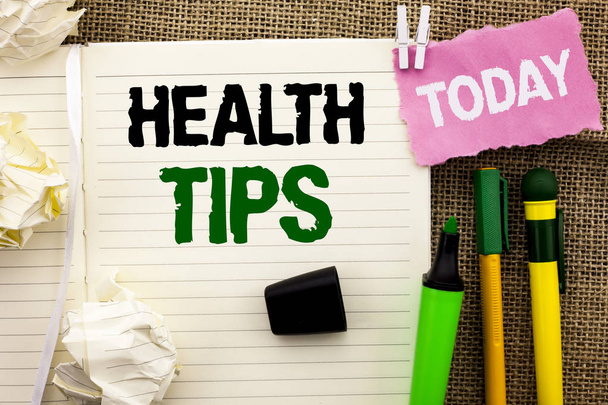 Writing note showing  Health Tips. Business photo showcasing Healthy Suggestions Suggest Information Guidance Tip Idea written on Notebook Book on the jute background Today Pens next to it. - Photo, Image