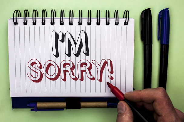 Writing note showing  I m Sorry. Business photo showcasing Apologize Conscience Feel Regretful Apologetic Repentant Sorrowful written by Man Holding Marker on Nootbook Book plain background Marker. - Photo, Image