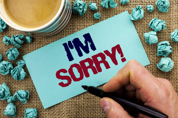 Writing note showing  I m Sorry. Business photo showcasing Apologize Conscience Feel Regretful Apologetic Repentant Sorrowful written by Man Holding Pen on Sticky Note Paper the jute background Cup - Photo, Image