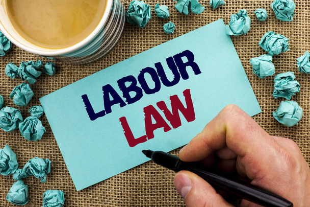 Writing note showing  Labour Law. Business photo showcasing Employment Rules Worker Rights Obligations Legislation Union written by Man Holding Pen on Sticky Note Paper the jute background Cup - Photo, Image