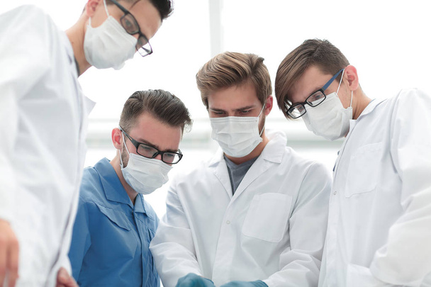 closeup. a team of doctors in protective masks. - Photo, image