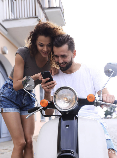 Happy young couple having summer trip on a scooter - Foto, Imagem