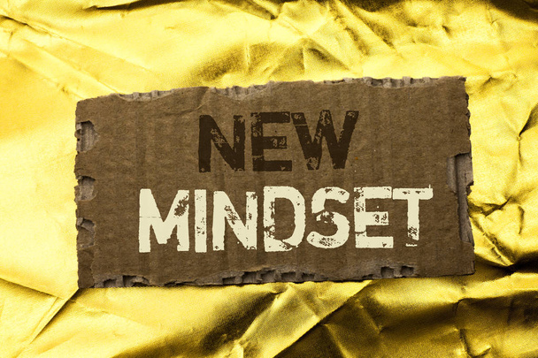 Word writing text New Mindset. Business concept for Attitude Latest Concept Vision Behaviour Plan Thinking written on tear Cardboard Piece on the Golden textured background. - Photo, Image