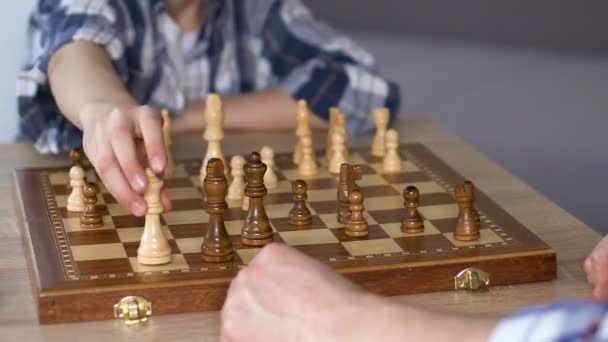 Smart boy wins chess with his father, brain training from early age, closeup - Séquence, vidéo