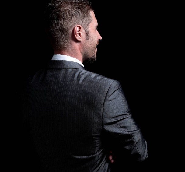 rear view .a confident businessman looks ahead. - Foto, afbeelding