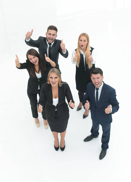view from the top.happy business team holding up a thumbs up. - 写真・画像