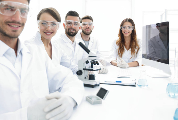 Male scientist and the team in the lab. - Fotó, kép
