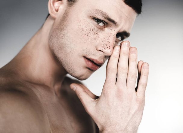 Pensive undressed male having freckles on face - Фото, изображение