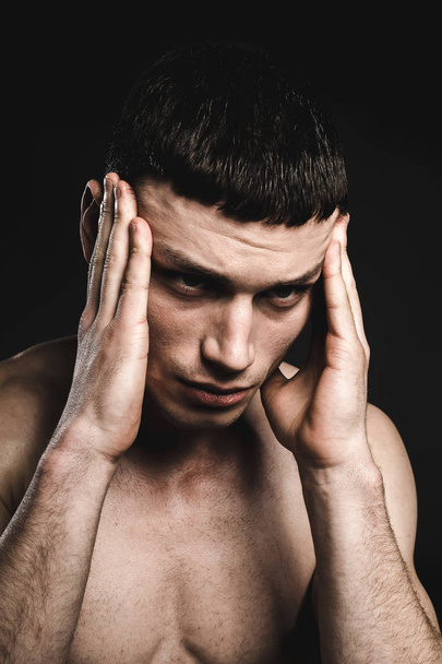 Dismayed bare-chested man having headache - Foto, Bild
