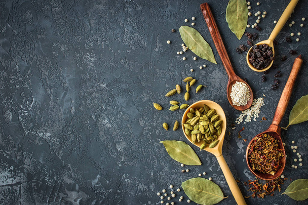 spices and herbs over black stone background - Photo, Image