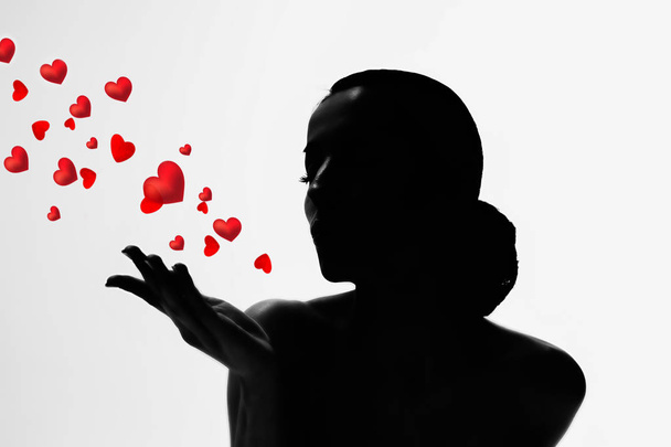 Beautiful and romantic silhouette of a young woman on a white background. The concept of love and congratulations. - Φωτογραφία, εικόνα