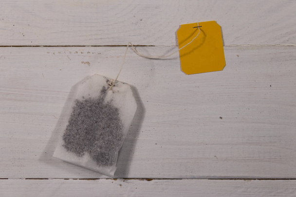 Tea bag on white wooden table. Top view - Photo, Image