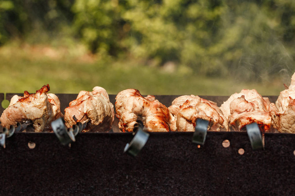 pieces of meat on skewers roasting on the grill. Shish kebab, bbq, pork. - Photo, Image