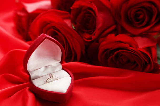 Bouquet of red roses with silver ring on satin - Foto, Bild