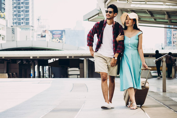 Couple Asian travelers are walking and enjoying vacations on city street. Travel concept - Photo, Image