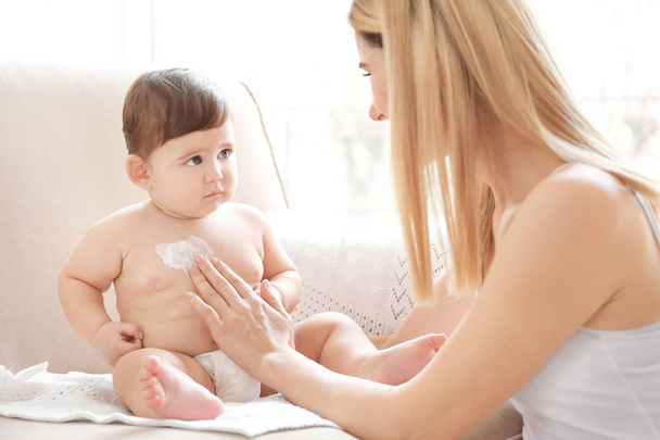 Woman applying cream on baby  - Foto, Imagem
