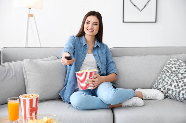 Young woman watching TV  - Фото, изображение