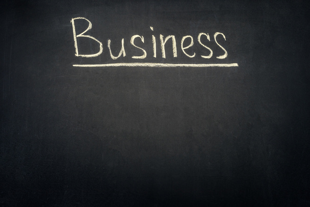 Business underlined inscription on dark chalkboard - Фото, изображение