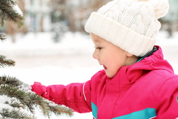 Cute little girl on frosty day outdoors. Winter vacation - Zdjęcie, obraz