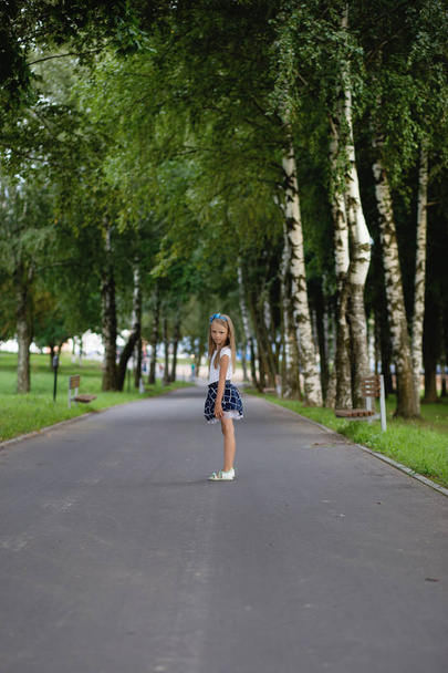 little girl with long hair plays on nature - Photo, image