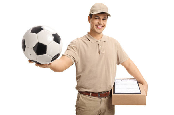 Delivery person holding a football isolated on white background - Foto, Bild