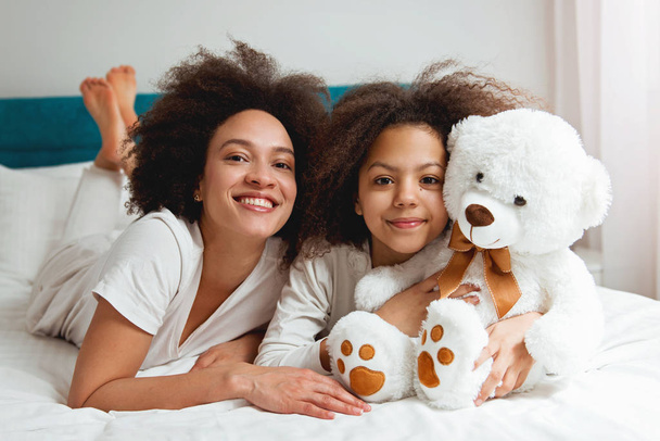 Mother and daughter enjoying on the bed, happy, smiling  - Fotoğraf, Görsel