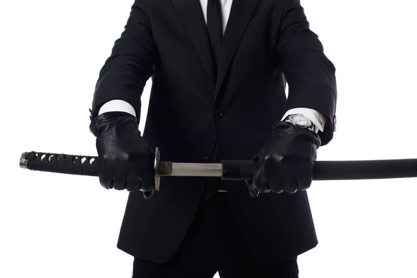 cropped shot of agent in gloves and suit with katana in hands isolated on white - Photo, Image