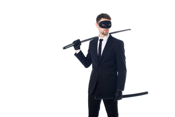 spy agent in mask and gloves with katana looking away isolated on white - Photo, Image