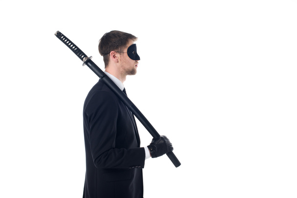 side view of spy agent in mask and gloves with katana isolated on white - Photo, Image