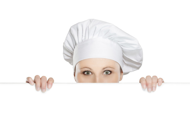 Chef mujer mirando sobre la cartelera
 - Foto, imagen