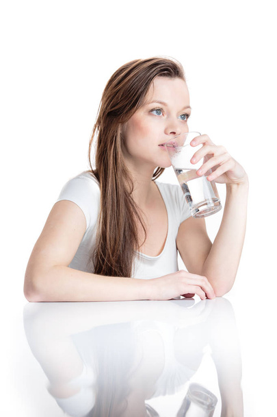 Closeup portrait of a young attractive woman drinking water  - Foto, Bild