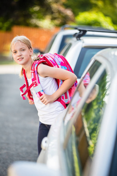 Cute little girl going home from school, looking well before cro - Foto, Imagen