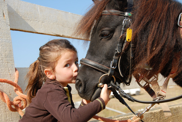 Little girl and her pony - Фото, изображение