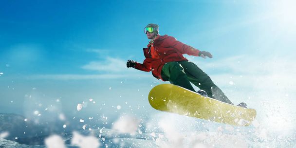 snowboarder jumping on speed slope, sportsman in action, winter active sport, extreme lifestyle - Photo, Image