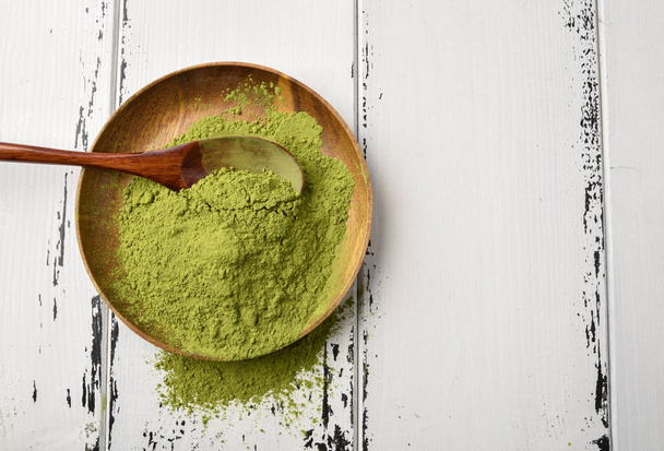 Green tea matcha powder in a wooden bowl - Photo, Image
