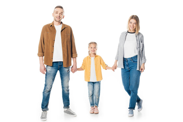 smiling family holding hands and looking at camera isolated on white - Foto, Imagem