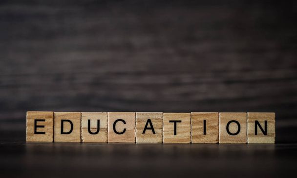the word education, consisting of light wooden square panels on  - Photo, Image