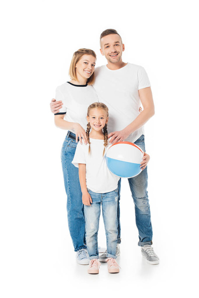 parents and kid in similar clothing with ball looking at camera isolated on white - Foto, Bild