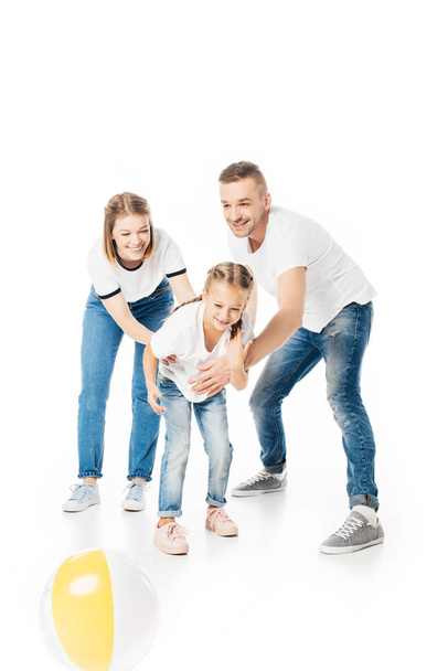parents and kid in similar clothing playing with ball isolated on white - Fotoğraf, Görsel