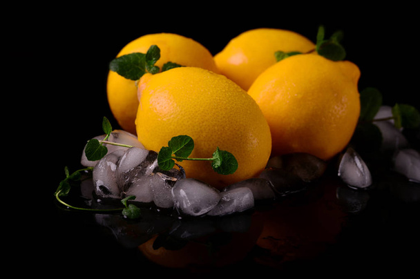 Lemons isolated on the black background. Top view - Фото, изображение